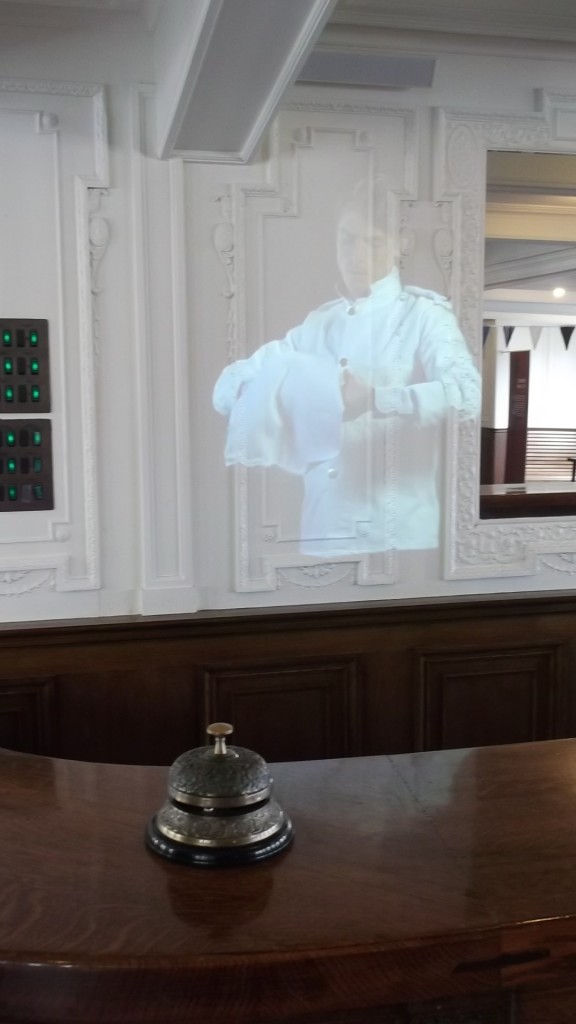 The barman, Louie, prepares drinks in the First Class cabin on board the SS Nomadic